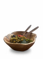 Natural Wonders USA medium cedar wood serving bowl filled with grapes and two wooden spoons. Rustic grain detail.