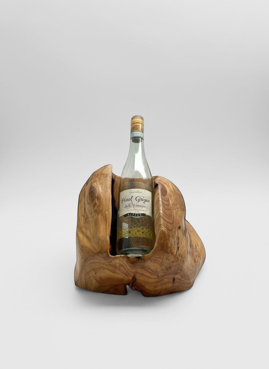 Natural Wonders USA cedar single bottle wine holder with rustic, carved design cradling a bottle of Pinot Grigio.