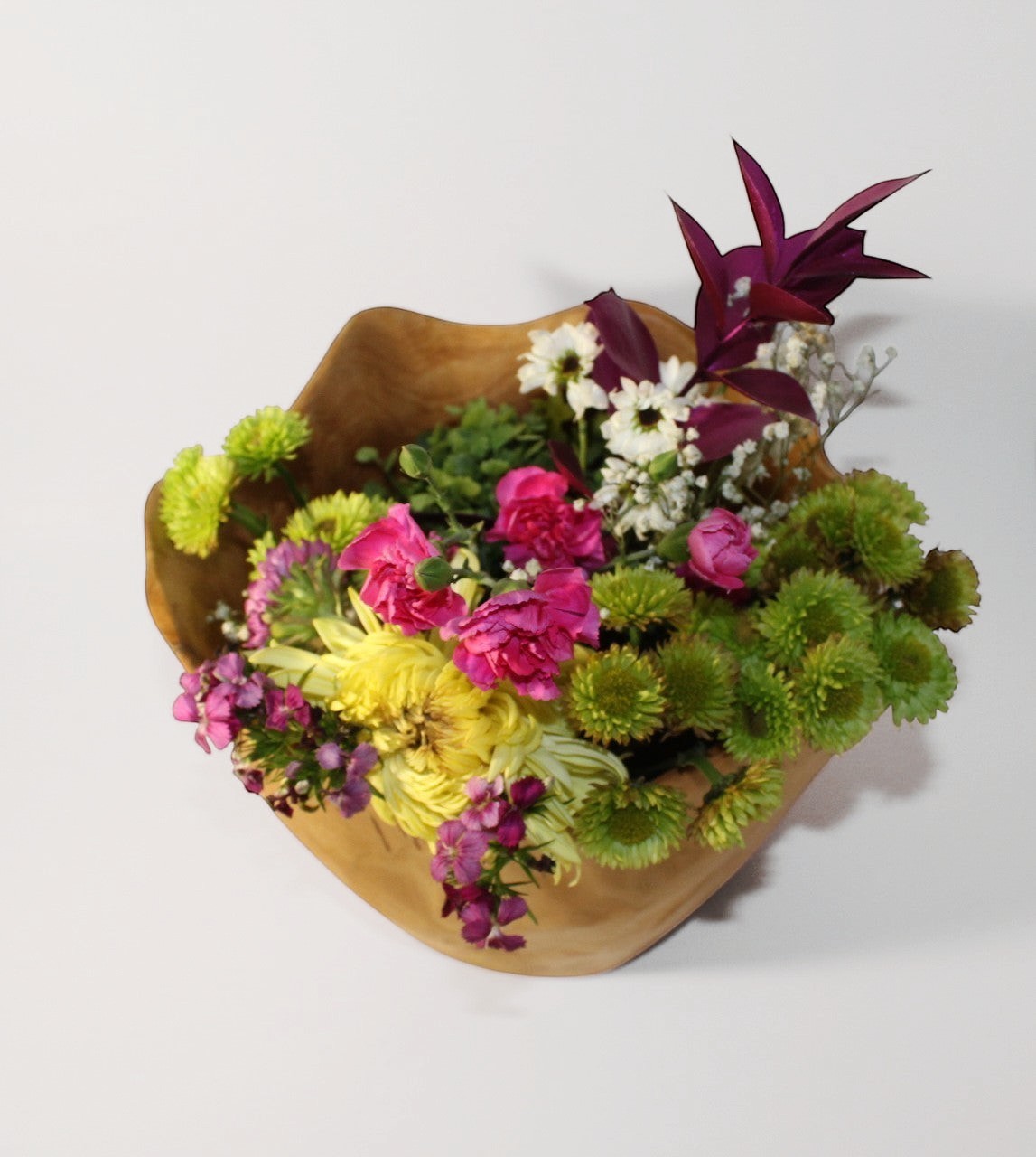 Natural Wonders USA handcrafted food-safe cedar wood bowl filled with colorful flowers, 8" tall.