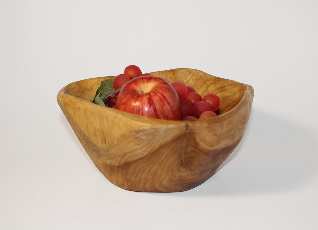 Natural Wonders USA cedar wood nibble dish with visible grain, holding an apple and grapes.