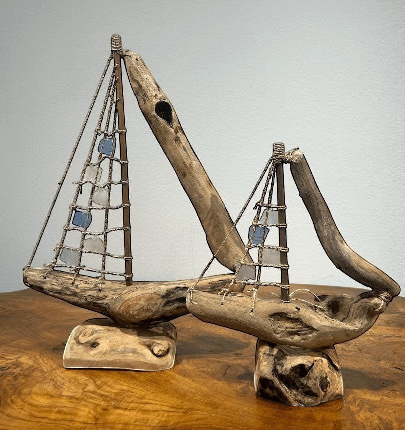 Natural Wonders USA sea glass and driftwood boat sculpture with blue and white sails on a wooden base. Nautical decor.