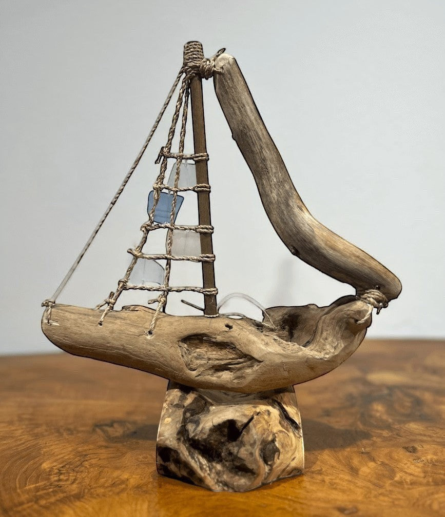 Natural Wonders USA sea glass and driftwood boat sculpture with blue and clear sails on a wooden base, 18