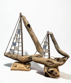 Natural Wonders USA sea glass and driftwood boat sculpture with blue and clear sails, 18" L x 15" H.