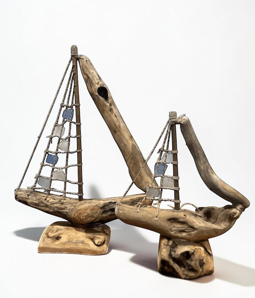 Natural Wonders USA sea glass and driftwood boat sculpture with blue and clear sails, 18