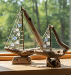 Natural Wonders USA sea glass and driftwood boat sculpture with white and blue glass sails, 18" L x 15" H.