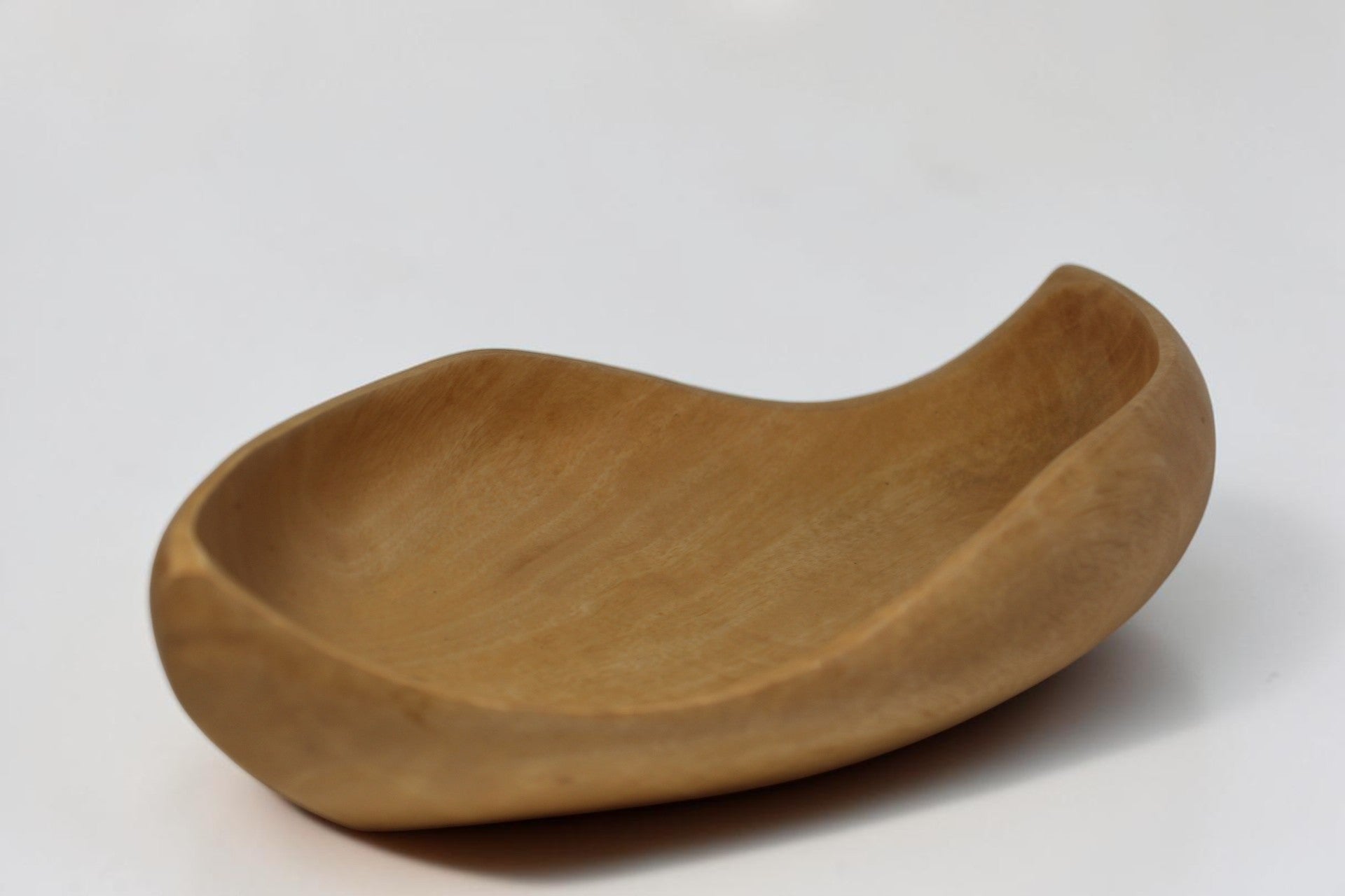 Natural Wonders USA hand carved light wood serving bowl with organic shape and matte finish.