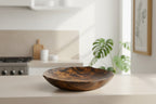 Natural Wonders USA hand carved dark wood serving bowl with organic shape and wavy grain pattern.