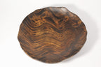 Natural Wonders USA hand carved dark wood serving bowl with organic shape and wavy grain patterns.
