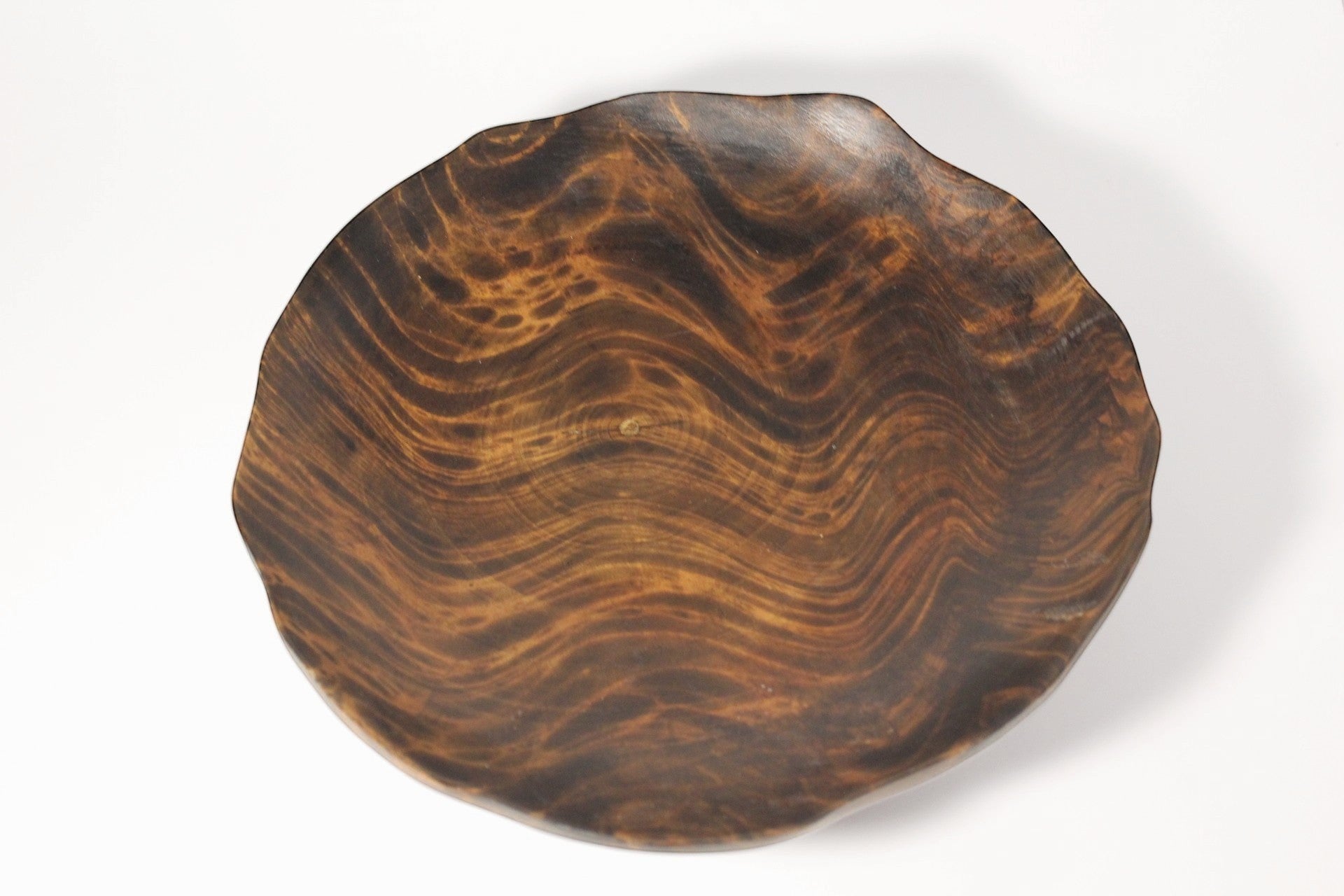Natural Wonders USA hand carved dark wood serving bowl with organic shape and wavy grain patterns.