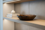Natural Wonders USA hand carved dark wood serving bowl with organic shape and wavy rim, showcasing natural grain patterns.