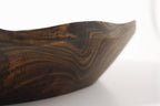 Natural Wonders USA hand carved dark wood serving bowl with organic shape and captivating grain patterns.