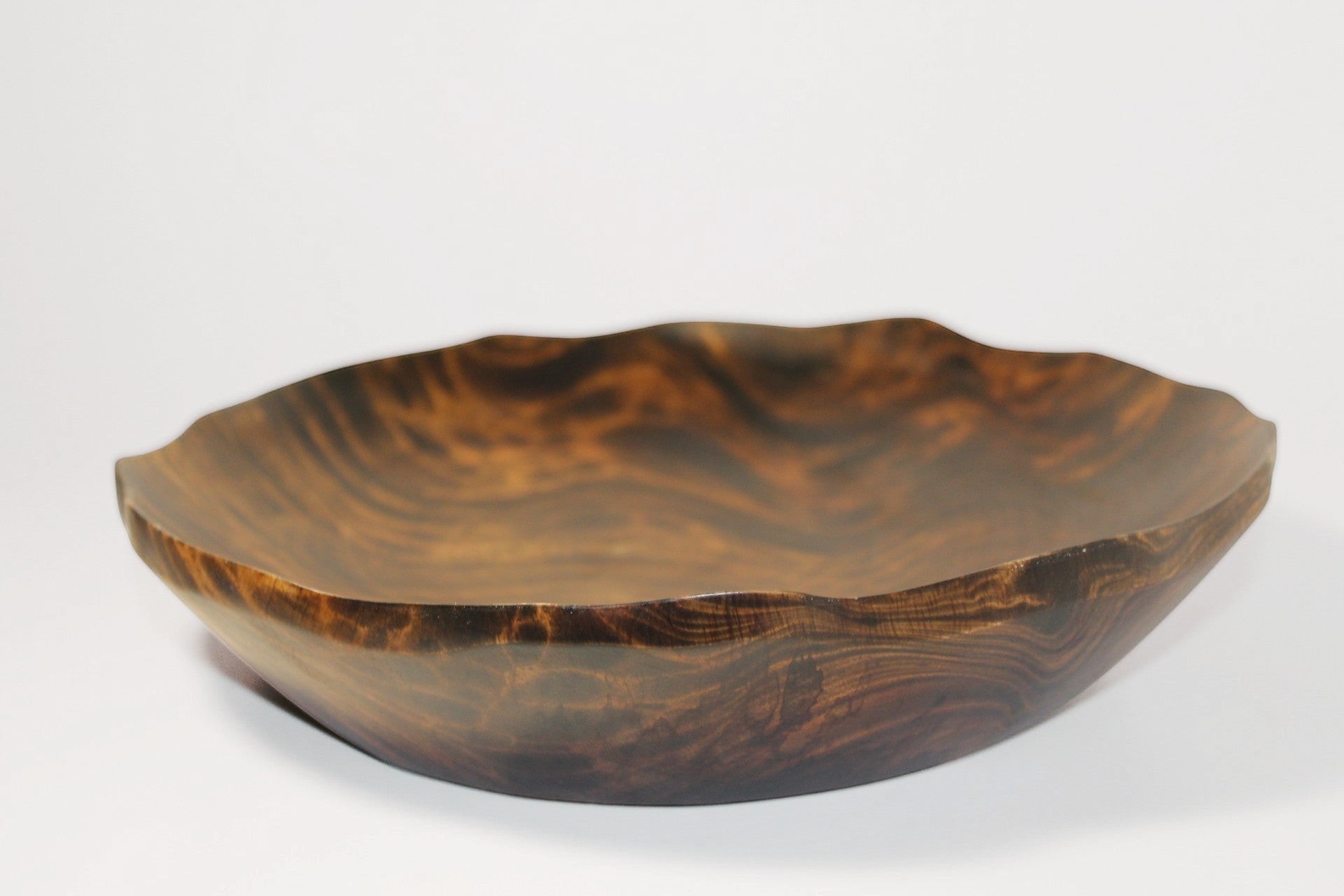 Natural Wonders USA hand carved dark wood serving bowl with organic shape and wavy rim. Unique grain patterns.