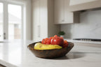 Natural Wonders USA hand carved dark wood serving bowl with organic shape, filled with red apple, grapes, and banana.