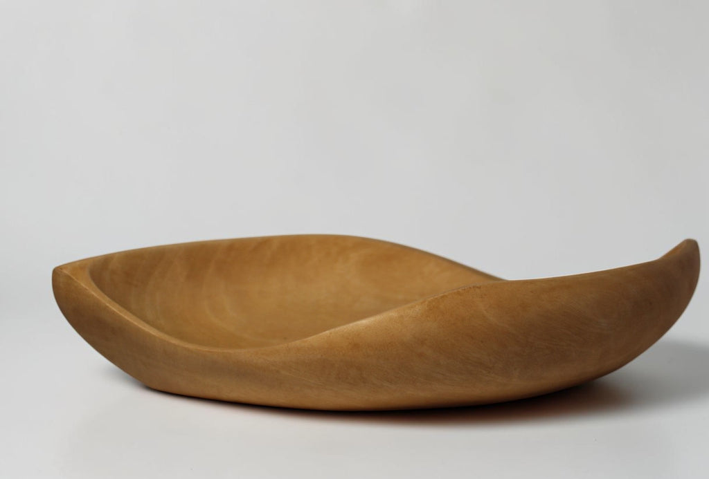 Natural Wonders USA hand carved light wood serving bowl with organic shape and matte finish.