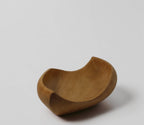 Natural Wonders USA hand-carved light wood serving bowl with organic, flowing shape and matte finish.