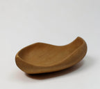 Natural Wonders USA hand carved light wood serving bowl with organic shape and matte finish.