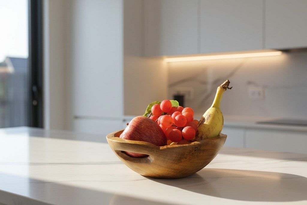 Natural Wonders USA hand carved wooden serving bowl with integrated handles, filled with fruit.