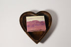 Natural Wonders USA dark wood heart-shaped serving bowl with layered pink and white soap.