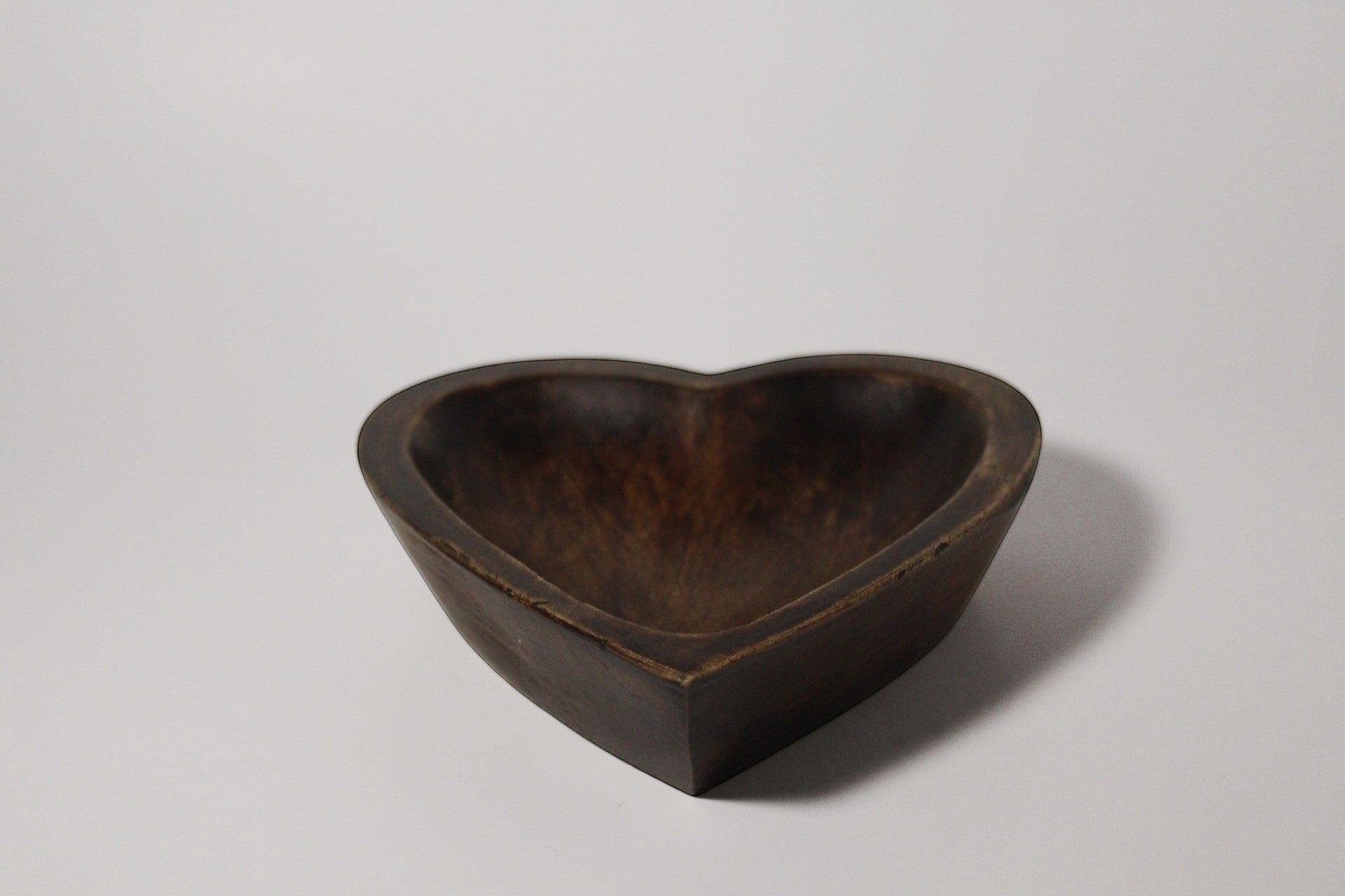 Natural Wonders USA dark wood heart-shaped serving bowl with natural grain detail, perfect for snacks or decor.
