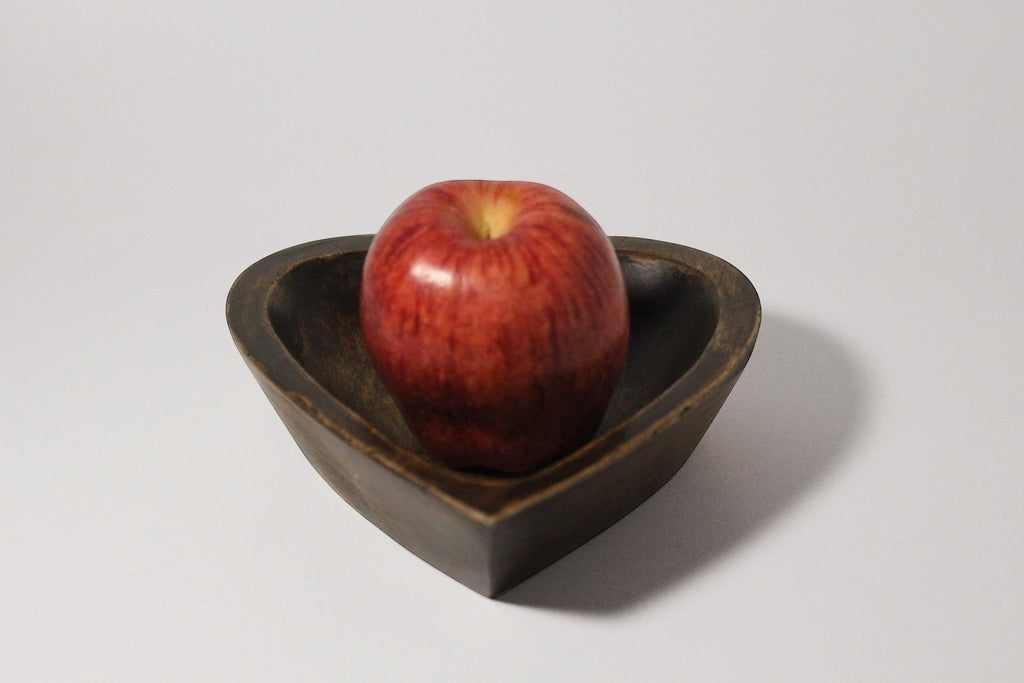 Natural Wonders USA dark wood heart-shaped serving bowl with a red apple inside. Rustic charm.