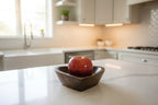 Natural Wonders USA dark wood heart-shaped serving bowl with a red apple inside.