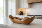 Natural Wonders USA rustic wooden trough bowl, handcrafted from a single piece of solid wood with natural grain and irregular edges.