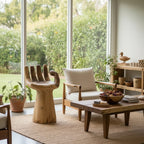 Natural Wonders USA solid teak wood hand chair, a unique accent piece with detailed carving and a pedestal base.