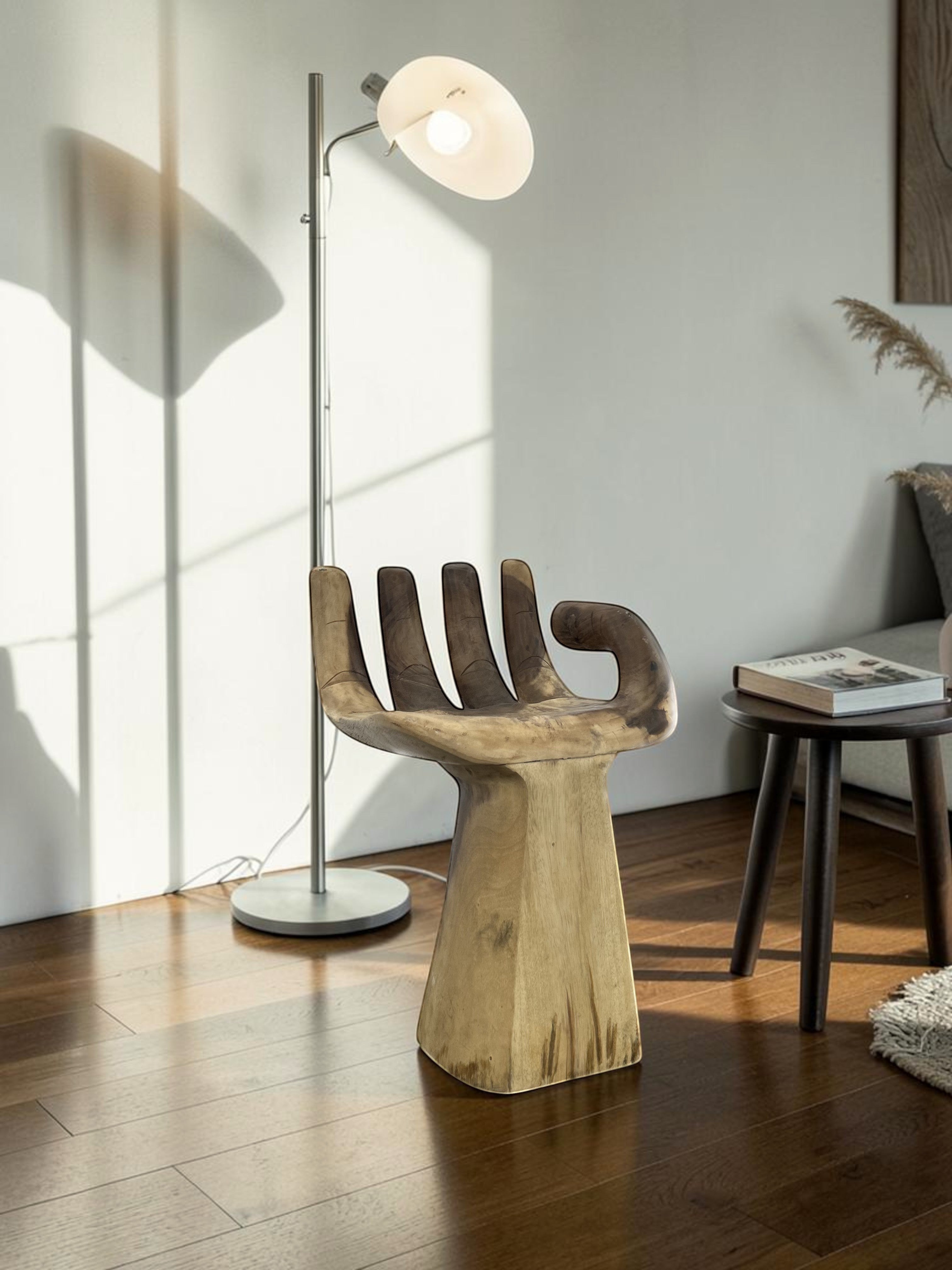 Natural Wonders USA Teak Hand chair, a unique solid teak wood seat carved to resemble a human hand with intricate detailing and a smooth finish.