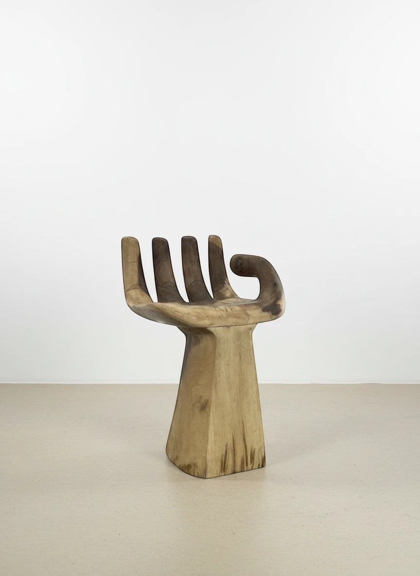 Natural Wonders USA Teak Hand Chair, a unique accent chair carved from solid teak wood in a stylized hand shape with a pedestal base.