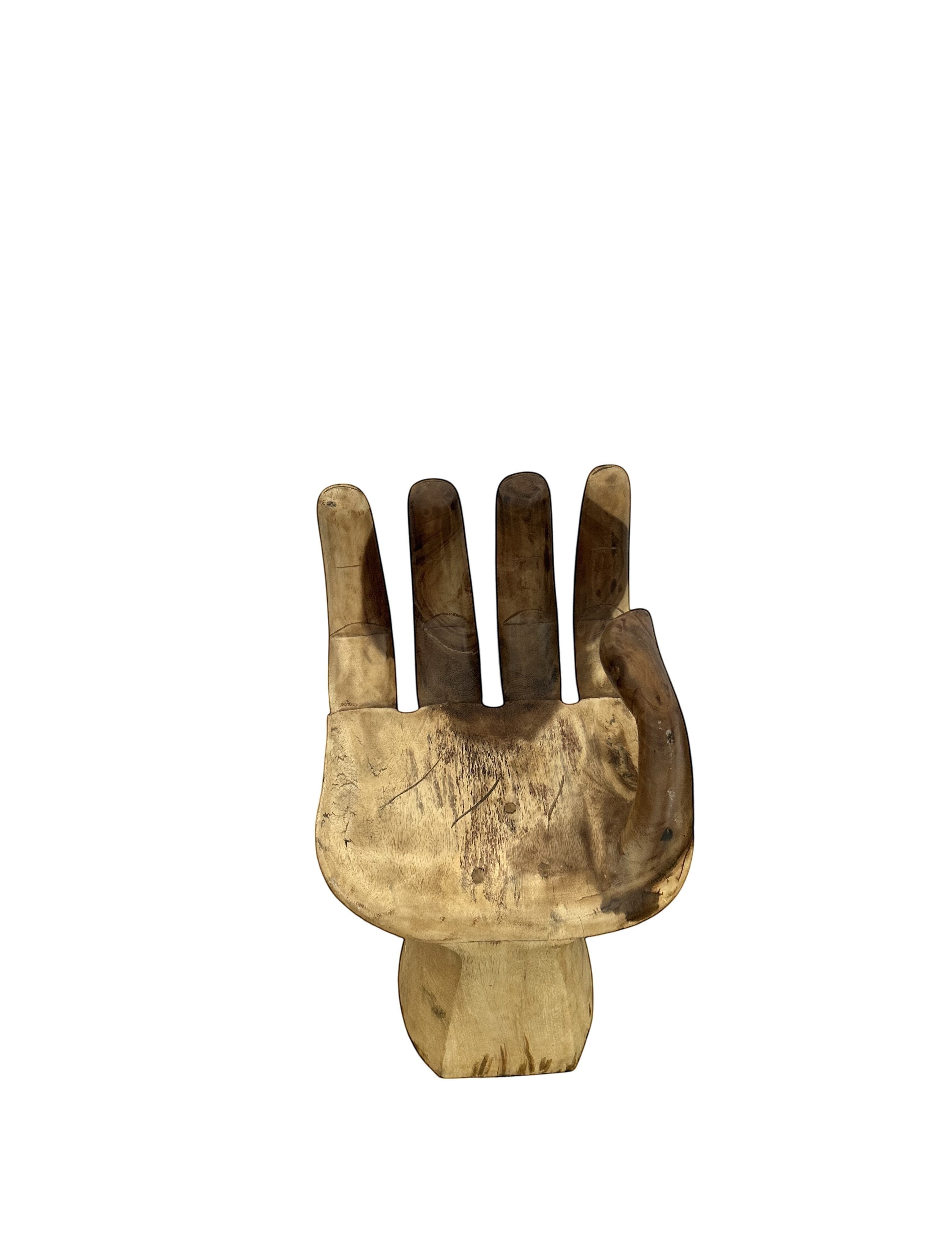 Natural Wonders USA Teak Hand chair, carved from solid teak wood, featuring a realistic hand design with intricate detailing and a smooth finish.