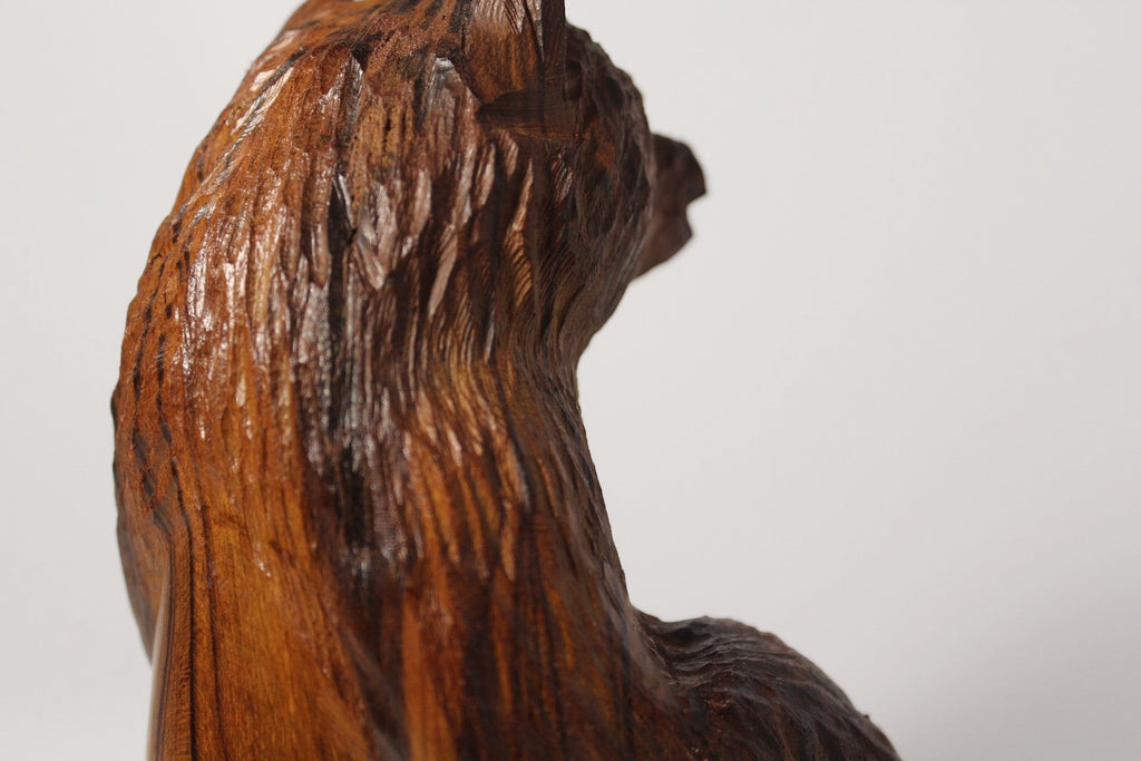 Rustic hand carved wooden bear figurine from Natural Wonders USA, showcasing intricate details and warm, earthy tones.