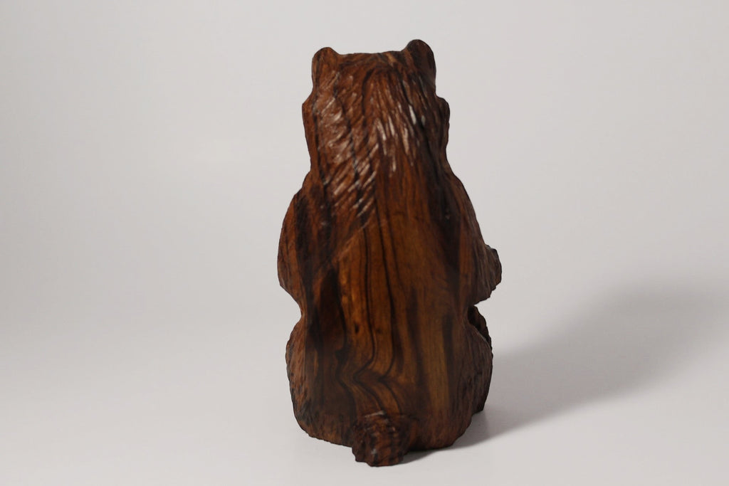 Natural Wonders USA rustic hand carved wooden bear figurine, dark brown wood, seated pose, detailed fur texture.