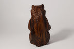 Natural Wonders USA rustic hand carved wooden bear figurine, dark brown wood, seated pose, detailed fur texture.