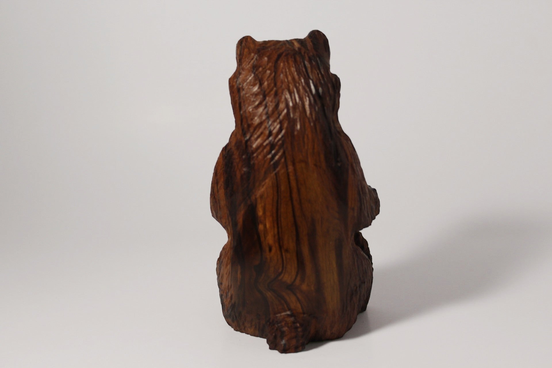 Natural Wonders USA rustic hand carved wooden bear figurine, dark brown wood, seated pose, detailed fur texture.
