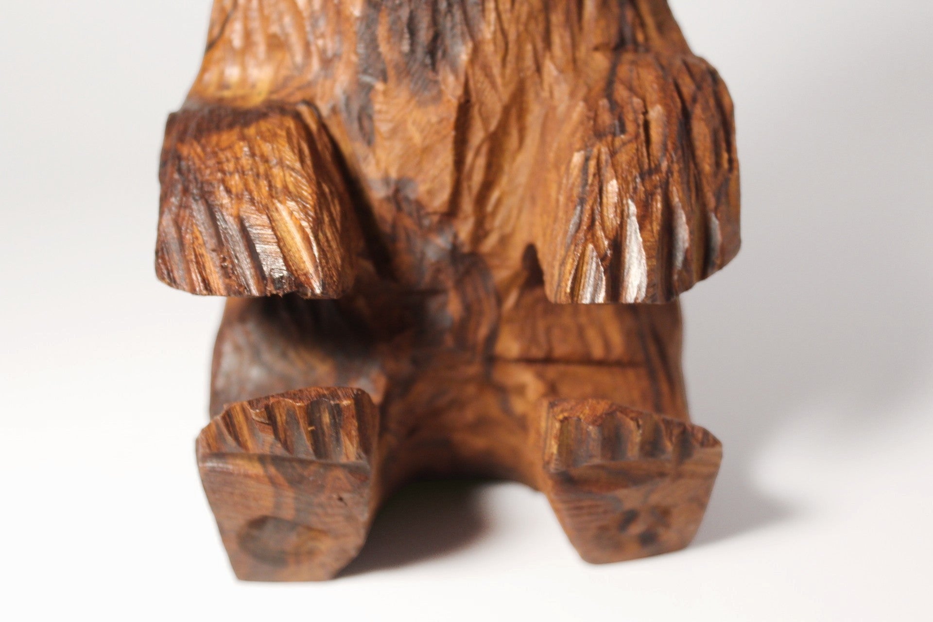 Natural Wonders USA rustic hand carved wooden bear figurine, seated position, detailed wood grain, warm earthy tones.