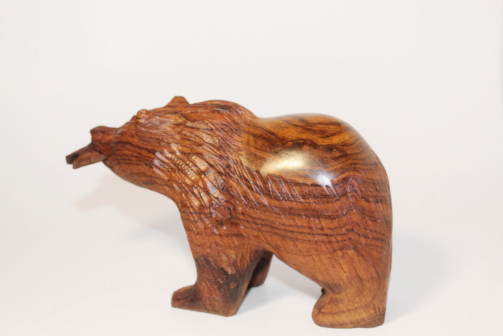 Natural Wonders USA hand-carved wooden bear figurine with fish in mouth, dark wood, rustic style.