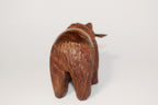 Natural Wonders USA hand-carved dark wood bear figurine with fish in mouth, rustic texture, detailed fur.