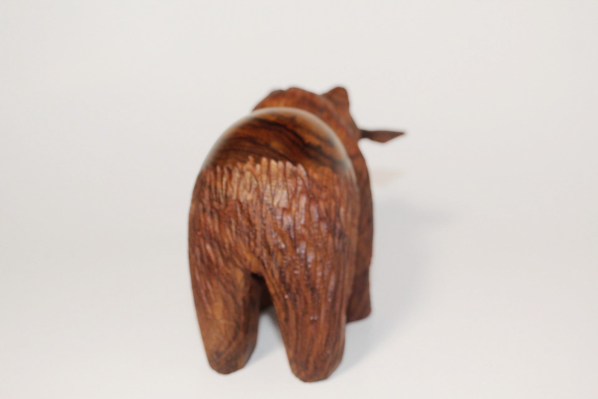 Natural Wonders USA hand-carved dark wood bear figurine with fish in mouth, rustic texture, detailed fur.