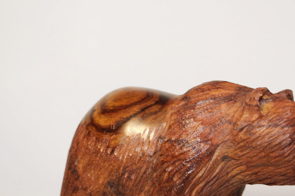 Natural Wonders USA hand-carved wooden bear figurine with fish, showcasing rich dark wood grain and intricate detail.