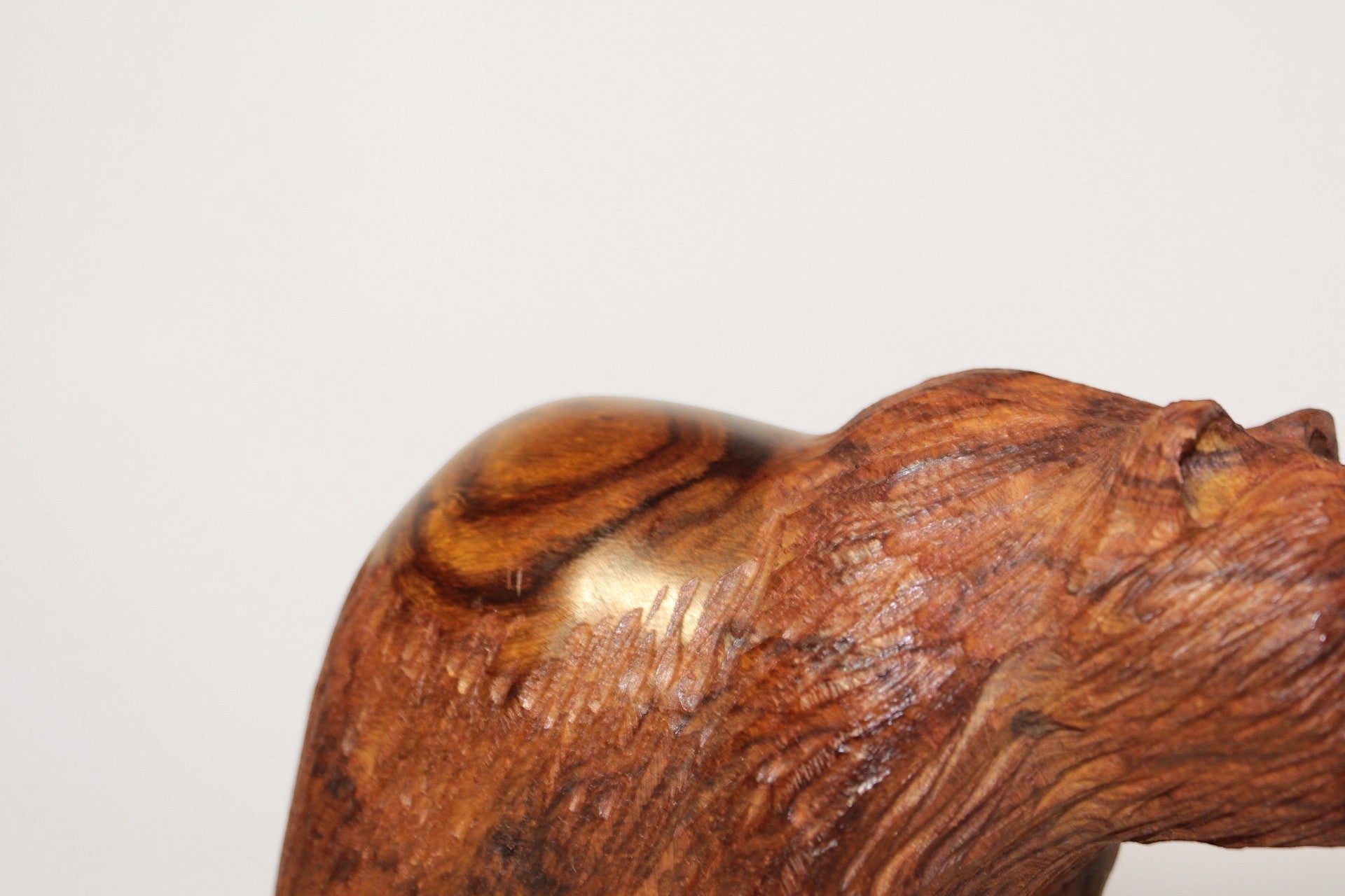 Natural Wonders USA hand-carved wooden bear figurine with fish, showcasing rich dark wood grain and intricate detail.