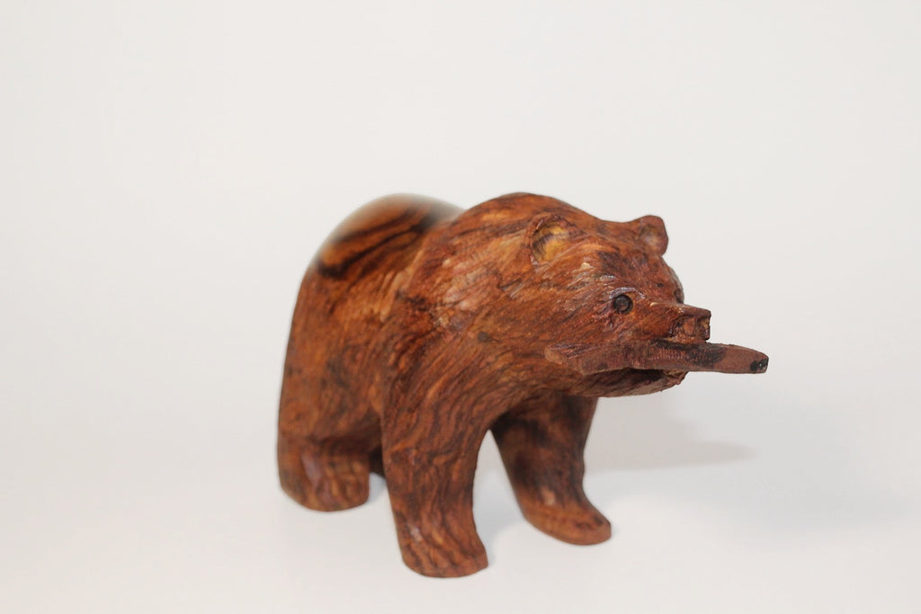 Natural Wonders USA hand-carved wooden bear figurine with fish in mouth. Dark wood with natural grain.