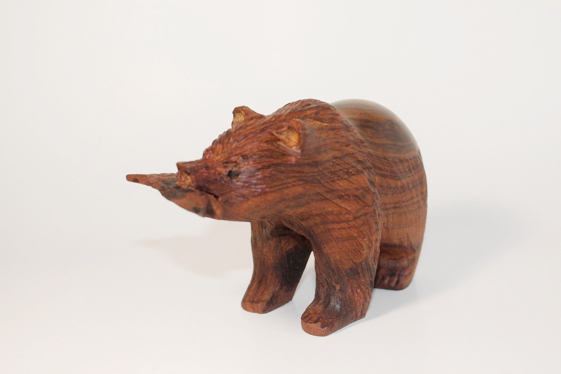 Natural Wonders USA hand-carved dark wood bear figurine with fish in mouth, rustic style.