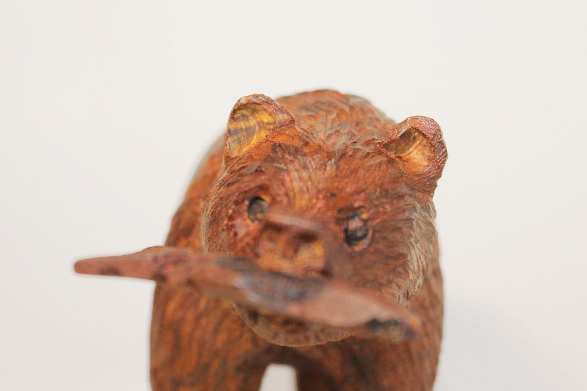 Natural Wonders USA hand-carved wooden bear figurine with fish in mouth, dark wood, rustic, detailed fur texture.