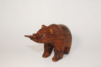 Natural Wonders USA hand-carved dark wood bear figurine with fish in mouth. Rustic, detailed sculpture.