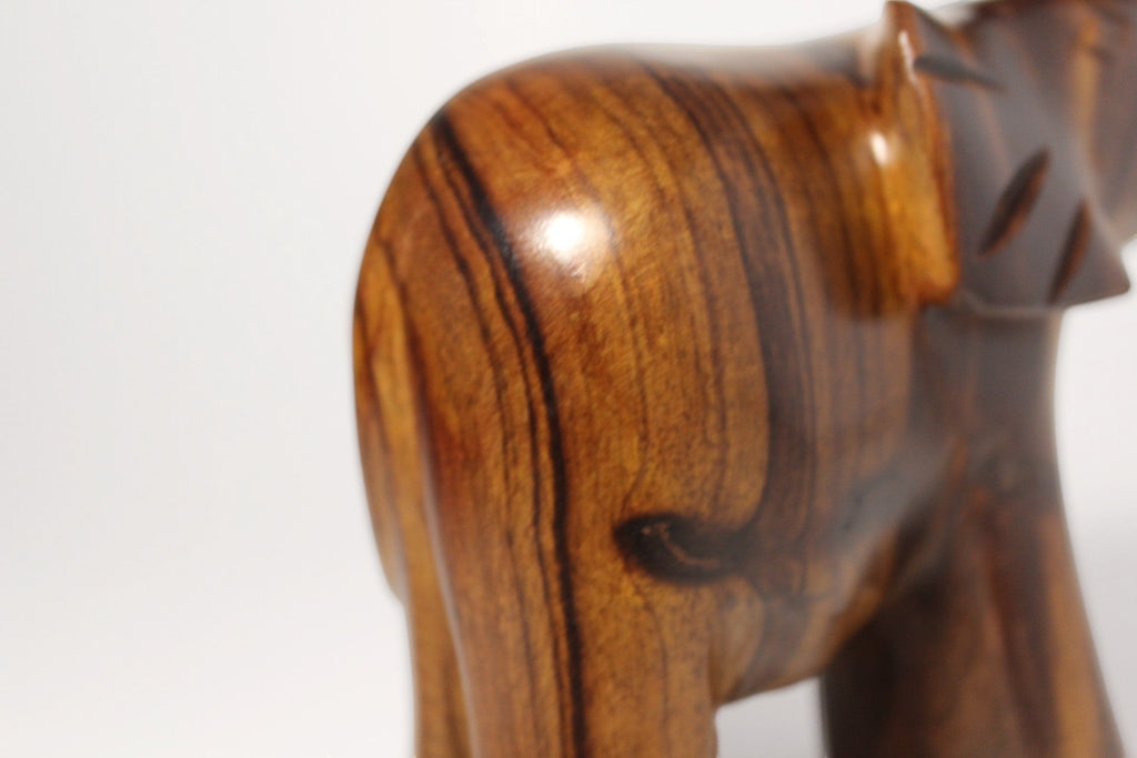 Natural Wonders USA dark wood elephant figurine with raised trunk, showcasing natural grain and carved details.