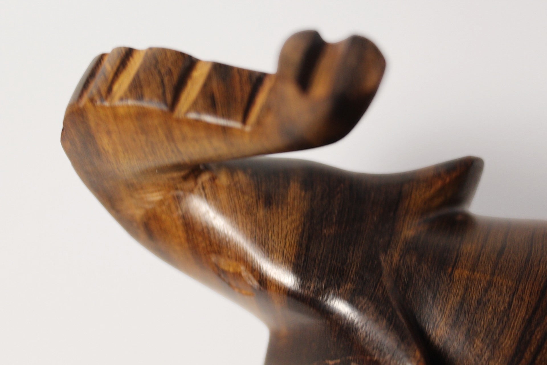 Natural Wonders USA dark wood elephant figurine with raised trunk, carved details, and natural grain.