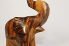 Natural Wonders USA dark wood elephant figurine with raised trunk, carved details, and natural grain.