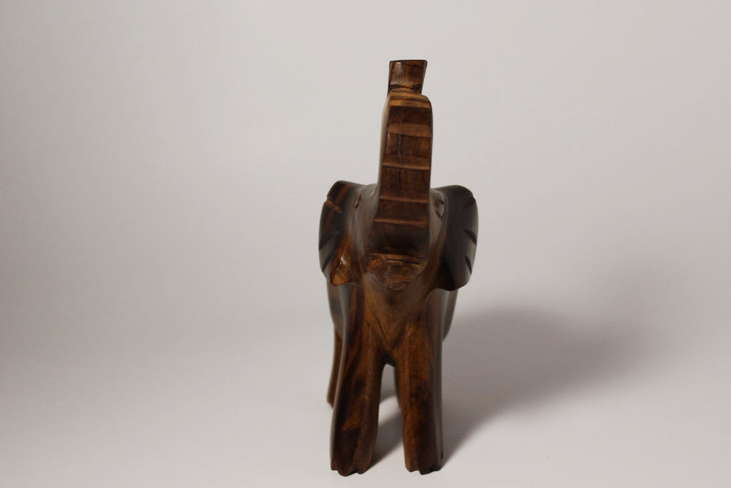 Natural Wonders USA dark wood elephant figurine with raised trunk, carved details, and natural grain.