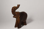 Natural Wonders USA dark wood elephant figurine with raised trunk, carved details, and natural grain.