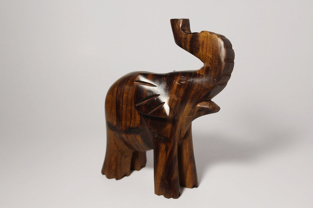 Natural Wonders USA dark wood elephant figurine with raised trunk, carved details, and natural grain.